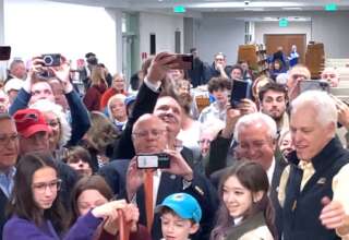 Library Building Committee Chairperson Jim Devol, far right, helped cut the ribbon for the newly renovated Swansea Free Public Library after thanking residents for their support.